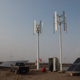 H2000 with its centre assist wheel (left) beside a different turbine model, a solar array and a site vehicle