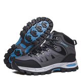 Pair of grey lace-up hiking boots with black mesh panels and a blue-and-black rubber lug sole