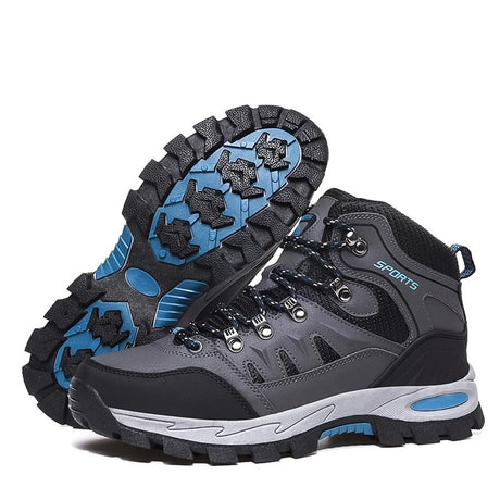 Pair of grey lace-up hiking boots with black mesh panels and a blue-and-black rubber lug sole