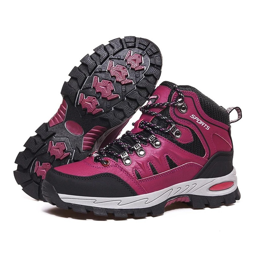 Pair of rose red lace-up hiking boots with black trim and a rose-and-black rubber lug sole