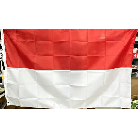 Indonesian flag in printed polyester held up indoors: red over white, white header strip at left