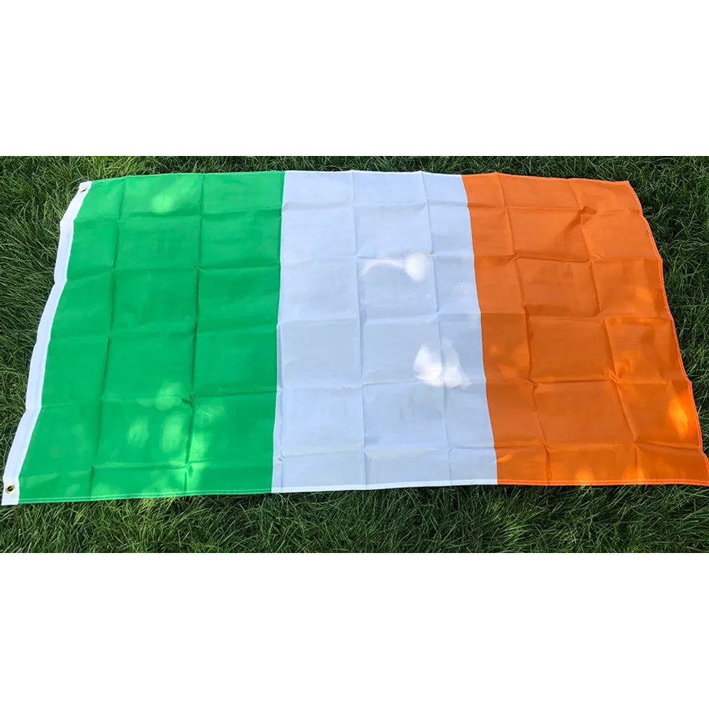 Irish flag in printed polyester laid flat on grass: green, white and orange, white header strip at left