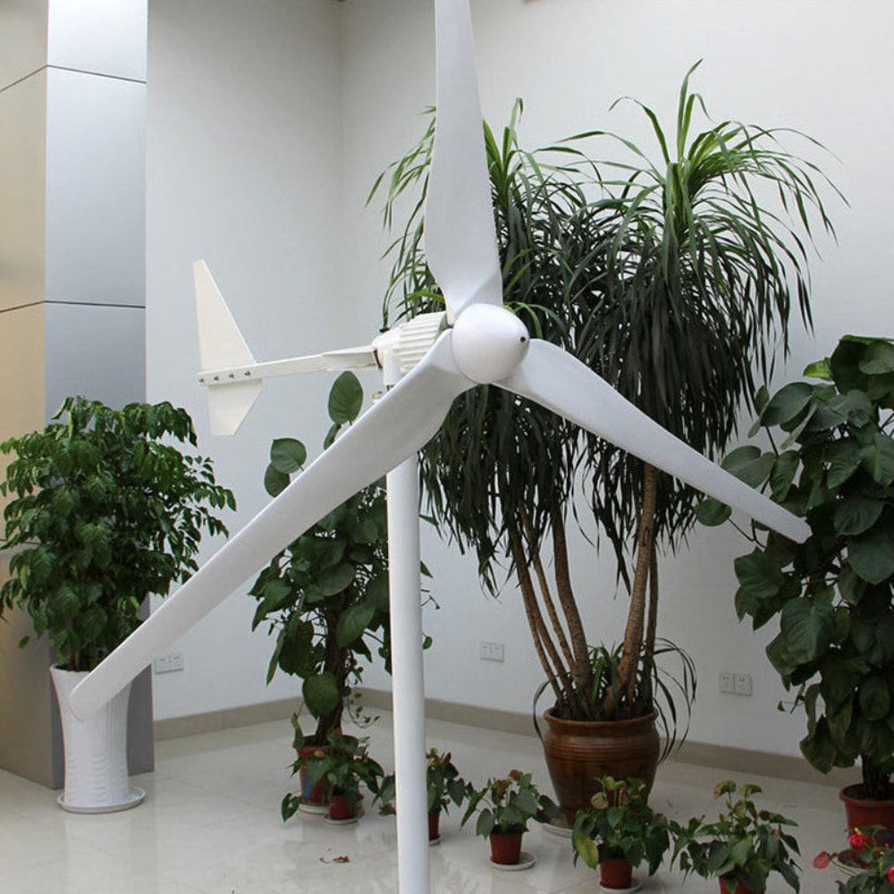 L-series three-blade horizontal-axis wind turbine displayed on a stand indoors among potted plants - representative family photo