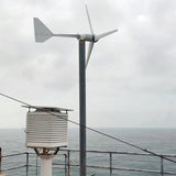 L-series wind turbine pole-mounted next to a weather station enclosure overlooking the sea - representative family photo