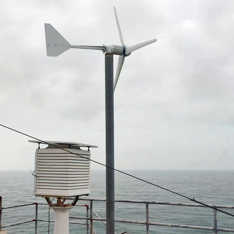 L-series wind turbine pole-mounted next to a weather station enclosure overlooking the sea - representative family photo