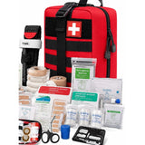 Red MOLLE first aid bag with a white cross patch, a tourniquet, bandages, dressings, plasters, gloves, trauma scissors and a card tool laid out in front