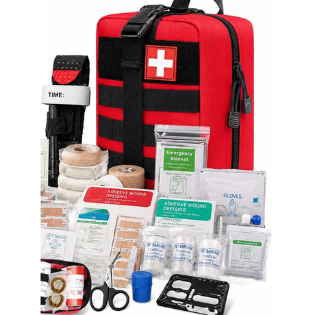 Red MOLLE first aid bag with a white cross patch, a tourniquet, bandages, dressings, plasters, gloves, trauma scissors and a card tool laid out in front
