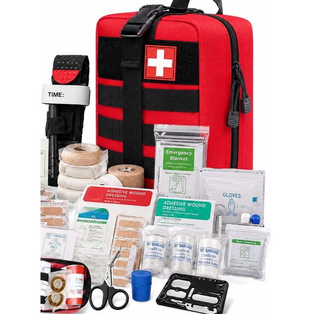 Red MOLLE first aid bag with a white cross patch, a tourniquet, bandages, dressings, plasters, gloves, trauma scissors and a card tool laid out in front