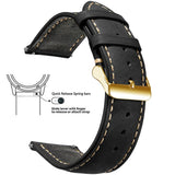 Black waxed leather band with cream stitching and a gold buckle