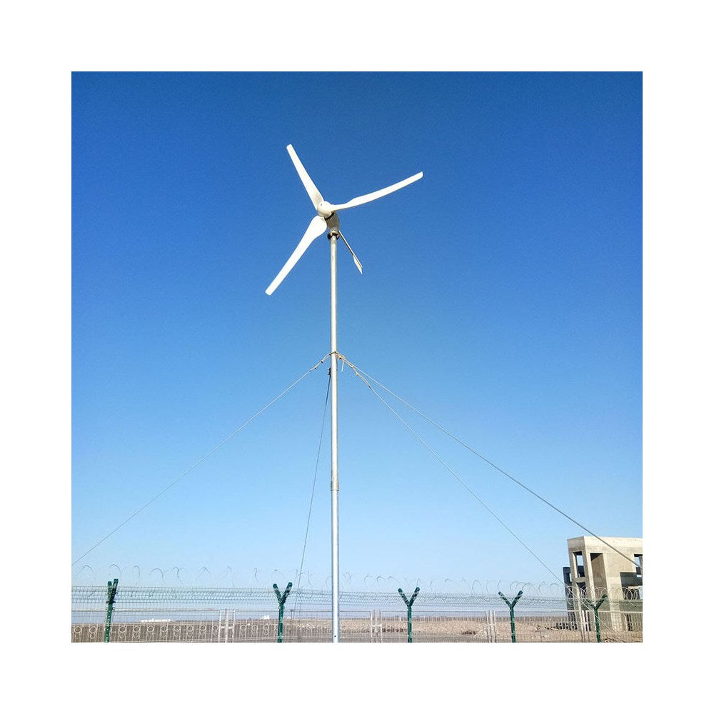 M-series horizontal-axis turbine on a guyed mast in open country under a blue sky - representative family photo