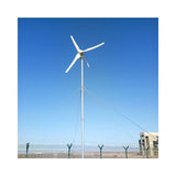 M-series horizontal-axis turbine on a guyed mast in open country under a blue sky - representative family photo