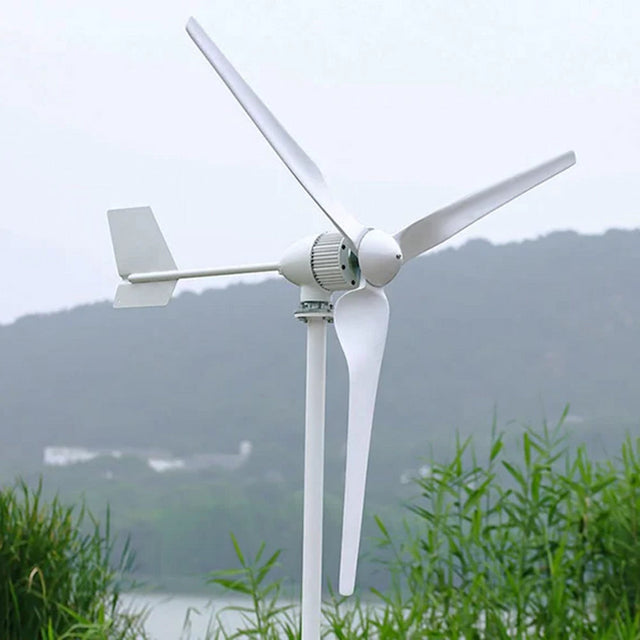 M5-800 close up on its pole: finned generator body, tail fin and three blades, with hills and water soft in the background