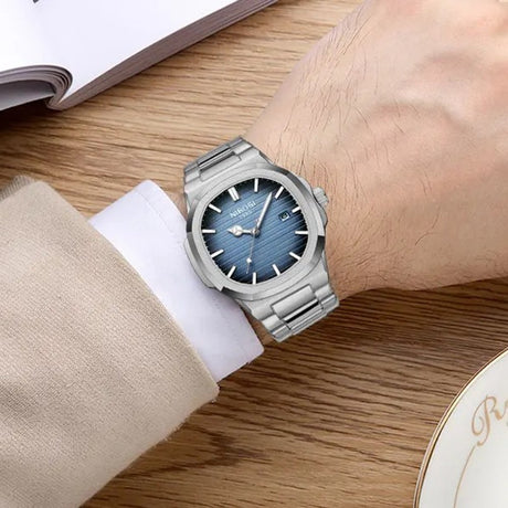 NIBOSI 2632 watch with blue dial and silver steel bracelet worn on the wrist