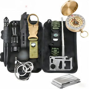 Survival kit laid out in an open black plastic case with pen, torch, spork, bottle clip, paracord bracelet, card tool, wire saw, lid compass and foil blanket