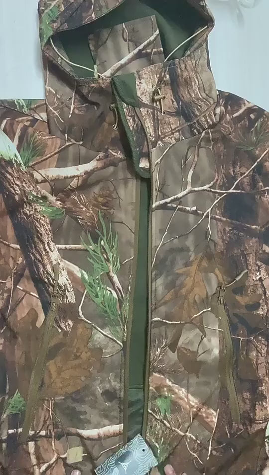 Hands opening the camo hooded jacket to show the green brushed fleece inside, the zips, the pockets and the hood.