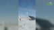 Video: an H2000 vertical wind turbine turning on its mast beside a solar array on a snowy plain, with captions for the 2000 W rating at 11 m/s, 2.1 m rotor, 2.5 m/s start-up and 50 m/s safe wind speed