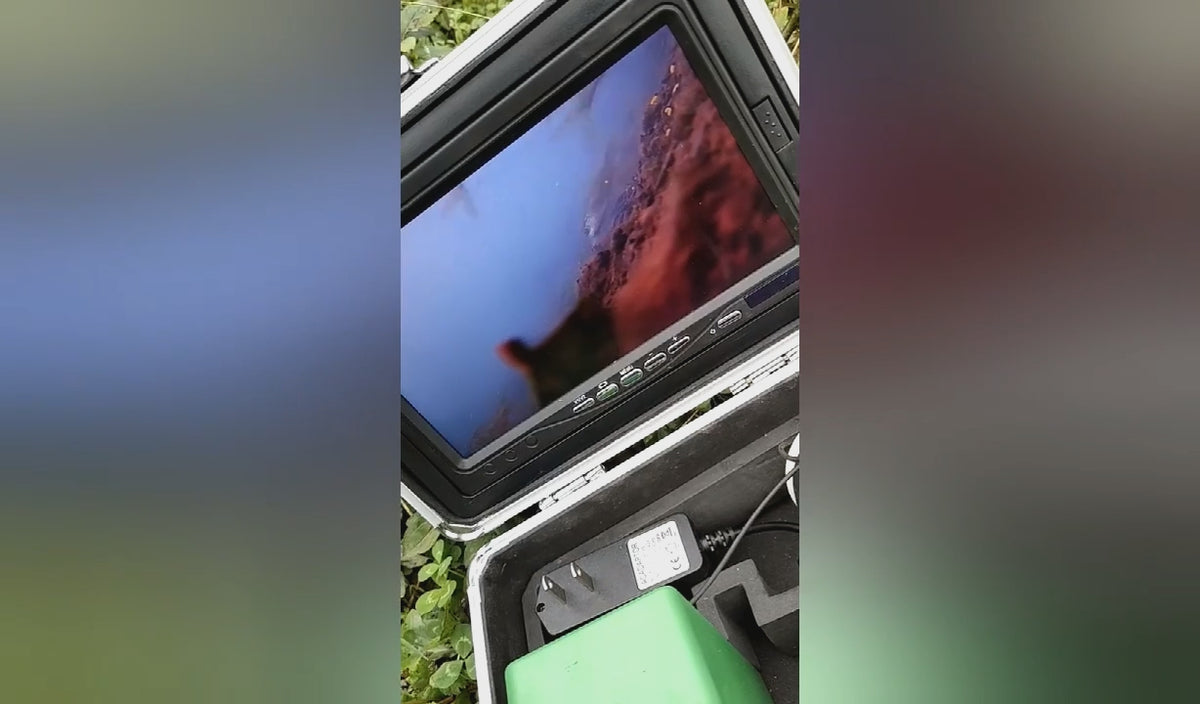 Underwater fishing camera kit in use: the 7 inch screen showing fish below the water, then the case unpacked with cable reel, screen hood, charger and float