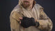 Model in the camo combat shirt and cargo pants showing the sleeves, the collar, the waist and the knee pads.
