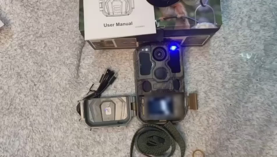 The trail camera on a carpet beside its box and cables, a hand pressing its buttons with the front panel open, then the camera strapped to a tree trunk and set up through its screen.