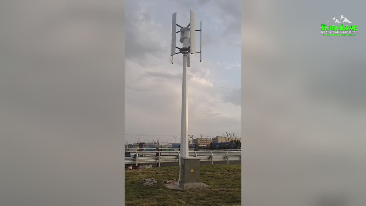 Video: H1000 vertical wind turbines turning on their masts at a roadside installation, including a crane lifting the rotor, with captions for the 1000 W rating at 11 m/s, 2.5 m/s start-up and 50 m/s safe wind speed