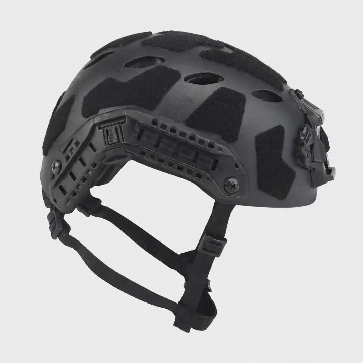 Black high-cut helmet turning slowly on a white background, showing the side rails, the front mount and the chin strap.