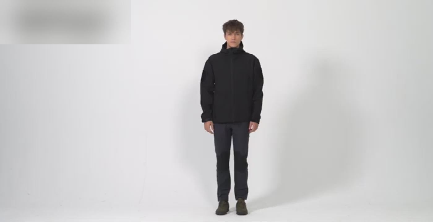 Man in the black TACVASEN fleece-lined softshell: the full zip, the arm pocket, the inside pocket, water beading off the front, and a walk-round.