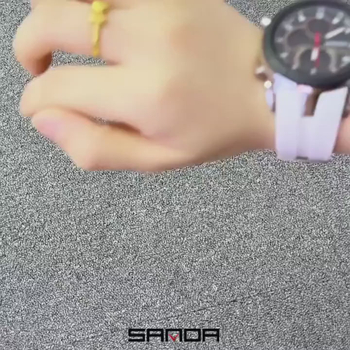The SANDA 6279 on a wrist with a white strap, a table of the watch in many strap colours, then the watch held in the hand with its digital windows lit green.