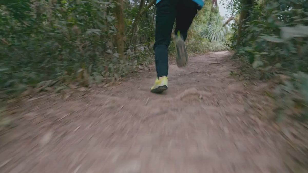 A runner on a forest trail checking the Mibro GS Active on his wrist, close-ups of the watch on rock and sand, a route in the phone app, and the four colours lined up at the end.