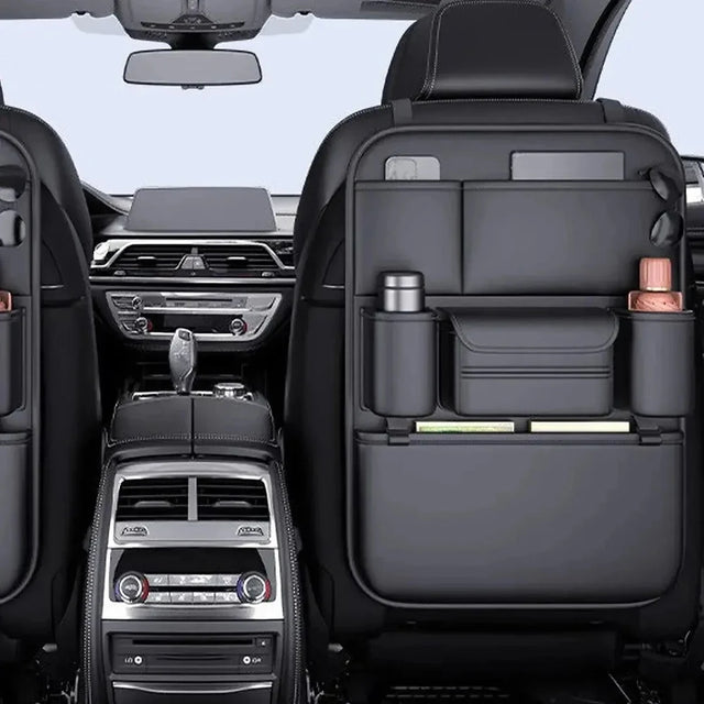 Black PU seat back organisers on both front seats, holding a tablet, phone, flask, drink bottle and books