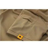 Close-up of the slit pocket and yellow star tab on the left sleeve