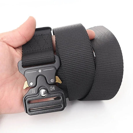 Black webbing belt held in one hand, showing the quick-release buckle and the coiled webbing
