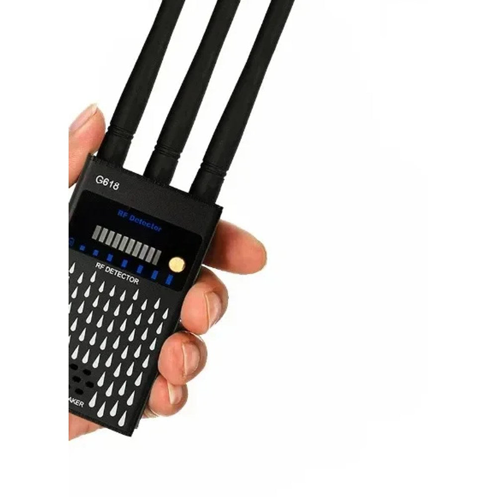 Hand holding the G618 RF detector at an angle, showing the LED signal meter and the three antennas