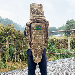 Camo tactical backpack with full-length tool sleeve worn on a person's back, outdoors