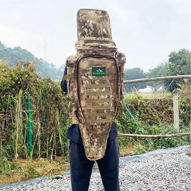Camo tactical backpack with full-length tool sleeve worn on a person's back, outdoors
