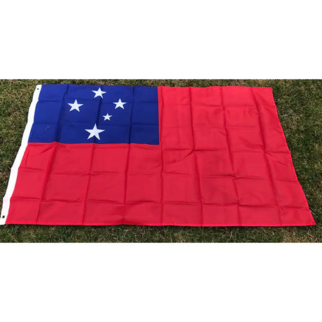 Samoan flag in printed polyester laid flat on grass: red with blue canton and five white stars, header strip at left