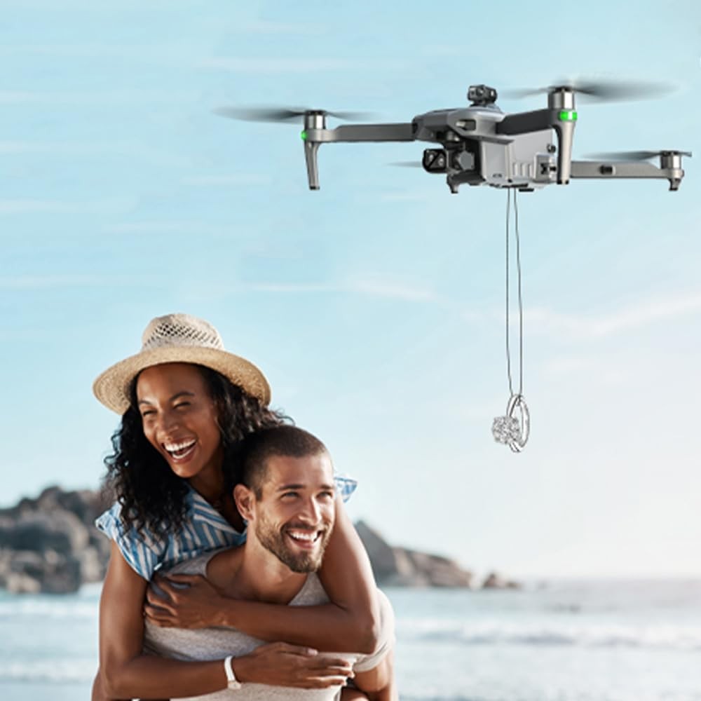 SG909MAX hovering over a couple on a beach, lowering a small gift on its release hook