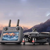 SG909MAX touch-screen remote and folded drone in front of a mountain backdrop