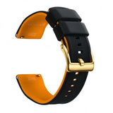 Black silicone band with an orange inner face and a gold buckle