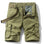 Khaki01 cargo shorts laid flat, front view, fly open to show the gingham check facing, metal tack button and D-ring on the waistband, with a tan webbing belt used for styling