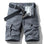 Grey RELAX six-pocket cargo shorts laid flat, front view, fly open to show the printed inner waistband, RELAX embroidery on the right cargo flap, with a dark grey webbing belt used for styling