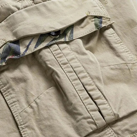 Close-up of a bellows cargo pocket on the khaki RELAX shorts with the flap lifted to show the camouflage print underneath