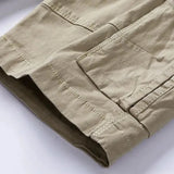 Close-up of the turn-up hem cuff with its darker contrast facing on the khaki RELAX shorts