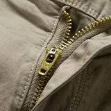 Close-up of the brass-toned metal zip fly with the pull stamped VEK on the khaki RELAX shorts
