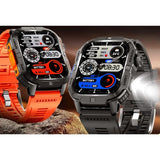 Two of the square watches on a rock, orange and black straps, the LED torch on the side lit