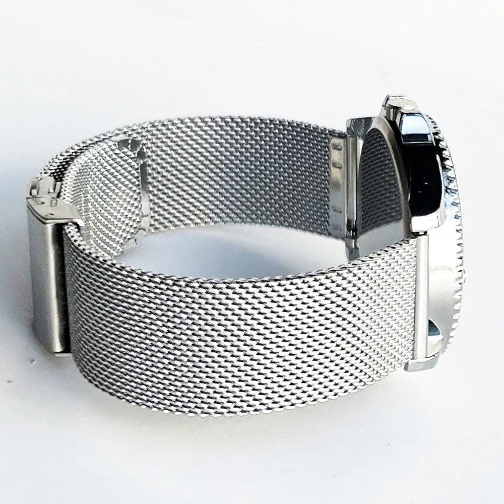 Silver mesh band fitted to a watch case, seen from the side with the clasp closed