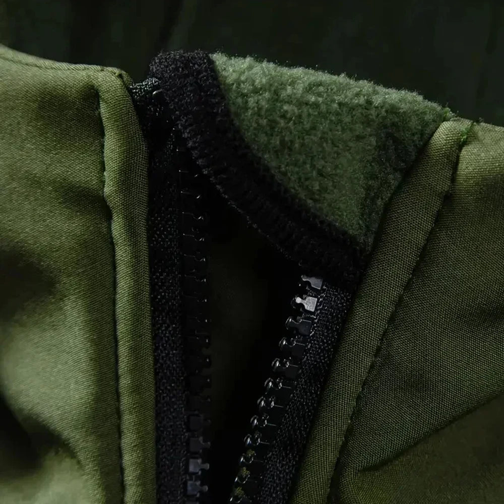 Close-up of the green jacket's collar opened at the zip, showing the soft fleece lining inside