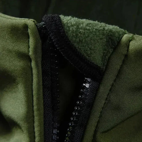 Close-up of the green jacket's collar opened at the zip, showing the soft fleece lining inside