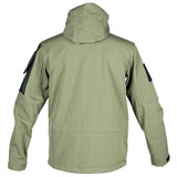 Back of the green softshell jacket with the hood down, black sleeve panels and the cuff tabs
