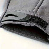 Close-up of a grey jacket cuff with its black hook-and-loop adjuster tab and the lining inside the sleeve