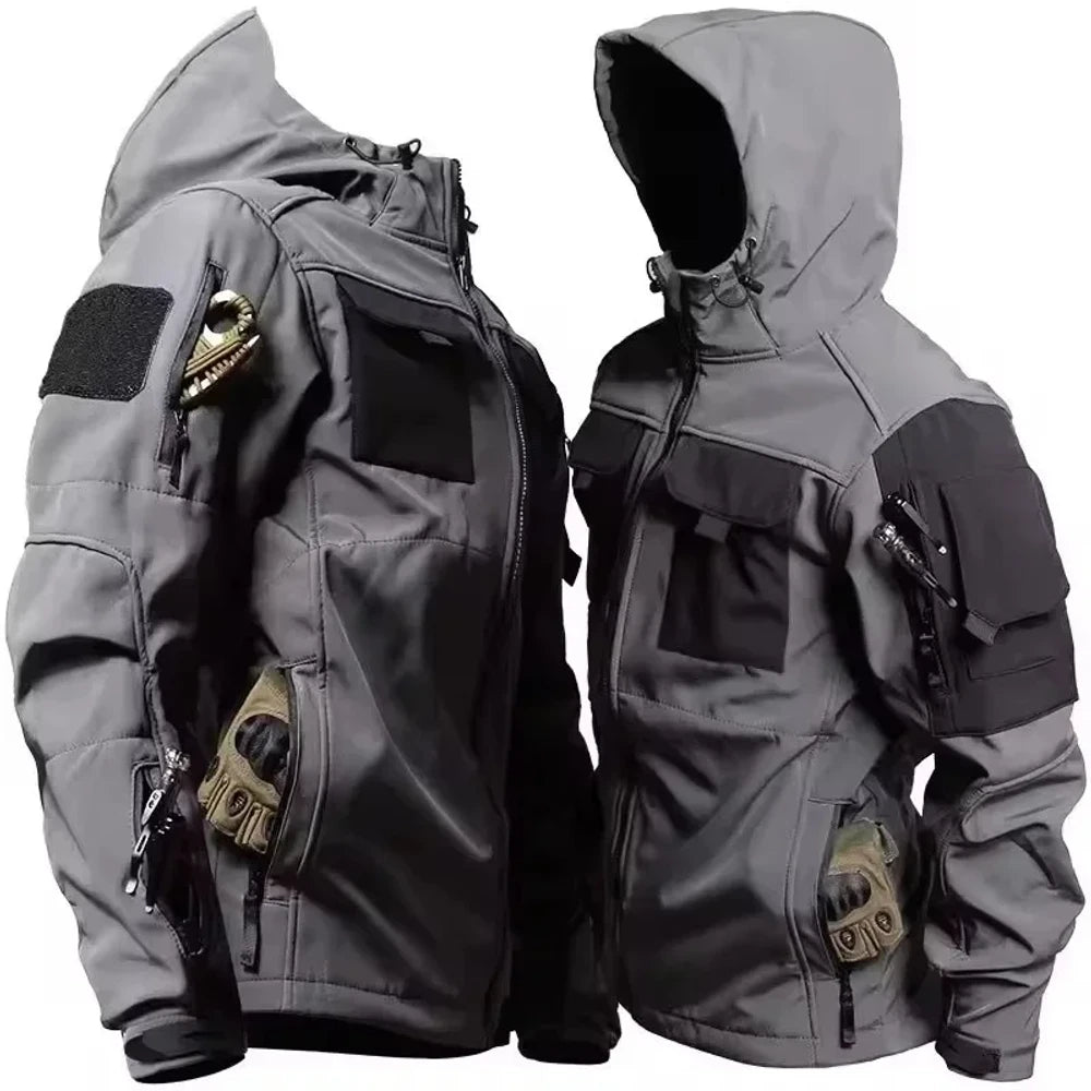Two grey softshell jackets with black chest and shoulder panels and a sleeve patch panel; clip and gloves not included